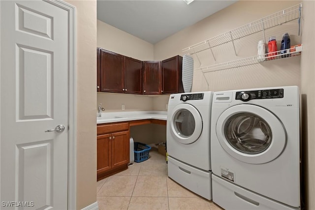 laundry room featuring sink, cabinets, independent washer and dryer, and light tile patterned flooring