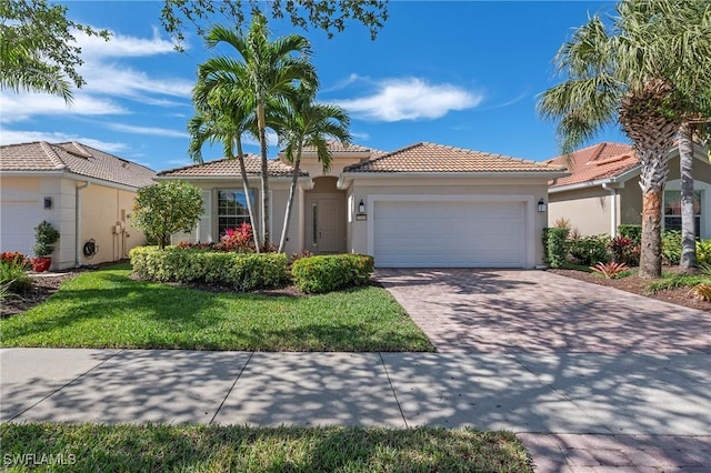 mediterranean / spanish-style home featuring a garage and a front yard