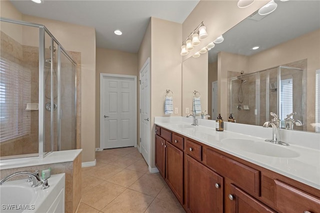 bathroom featuring tile patterned flooring, vanity, and shower with separate bathtub