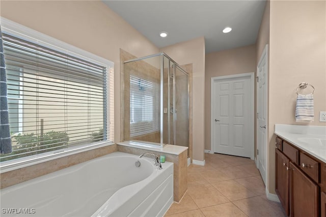 bathroom with tile patterned floors, separate shower and tub, and vanity