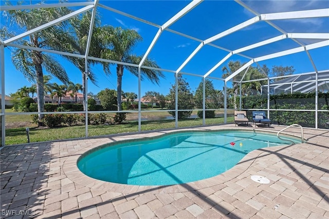 view of swimming pool with a patio area and glass enclosure