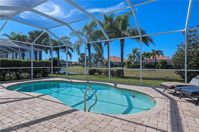 view of swimming pool featuring a lanai, a lawn, and a patio