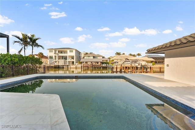 view of pool featuring a water view and a patio