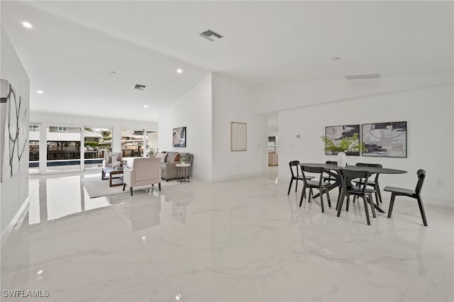 dining room featuring high vaulted ceiling