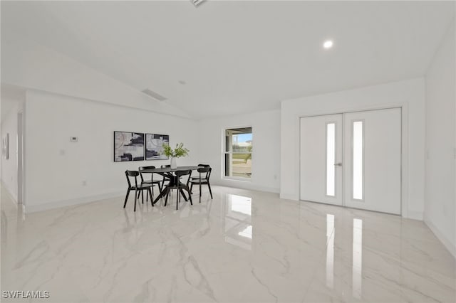 dining room with french doors and lofted ceiling