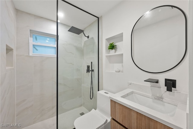 bathroom featuring vanity, toilet, and tiled shower