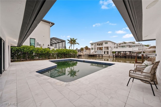 view of swimming pool featuring a water view and a patio area