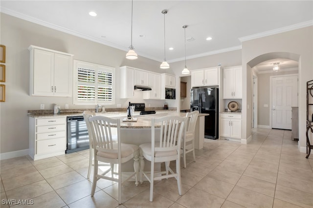 kitchen featuring pendant lighting, crown molding, white cabinetry, a center island, and black appliances