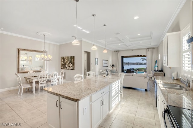 kitchen with crown molding, a center island, sink, and white cabinets