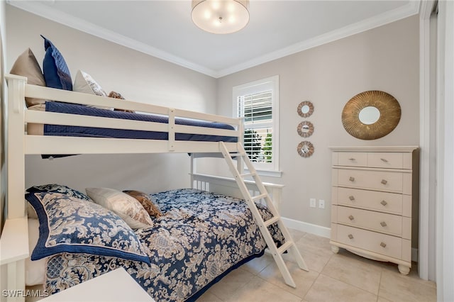 bedroom with ornamental molding and light tile patterned flooring