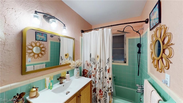 bathroom featuring vanity, backsplash, and shower / bath combination with curtain