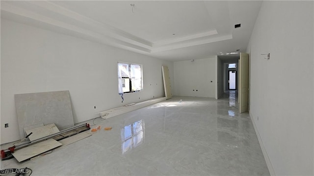 spare room with cooling unit and a tray ceiling