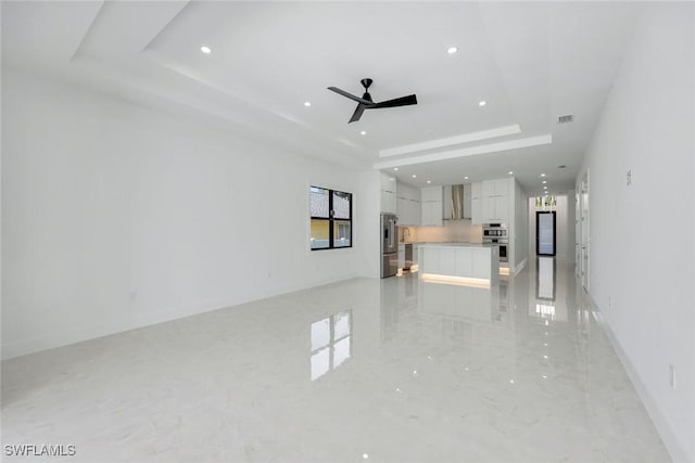 1312 Trail Terrace Dr, Naples, FL 34103 - unfurnished living room with a tray ceiling, ceiling fan, and recessed lighting