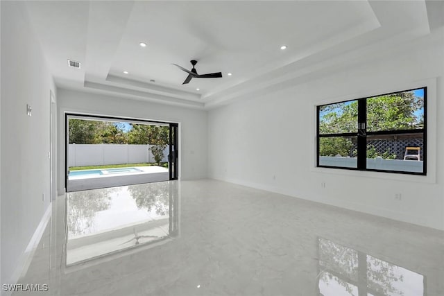 1312 Trail Terrace Dr, Naples, FL 34103 - spare room featuring a raised ceiling, plenty of natural light, ceiling fan, and recessed lighting
