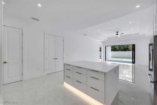 1312 Trail Terrace Dr, Naples, FL 34103 - kitchen with modern cabinets, a raised ceiling, recessed lighting, white cabinets, and a kitchen island