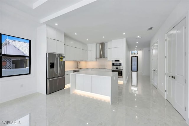 1312 Trail Terrace Dr, Naples, FL 34103 - kitchen featuring appliances with stainless steel finishes, wall chimney exhaust hood, modern cabinets, white cabinets, and light countertops
