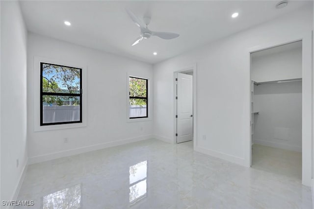 1312 Trail Terrace Dr, Naples, FL 34103 - unfurnished bedroom featuring recessed lighting, a walk in closet, baseboards, light marble finish floors, and ceiling fan