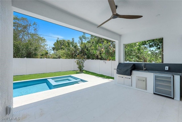 1312 Trail Terrace Dr, Naples, FL 34103 - fenced backyard with wine cooler, a ceiling fan, a sink, a patio, and a pool with connected hot tub