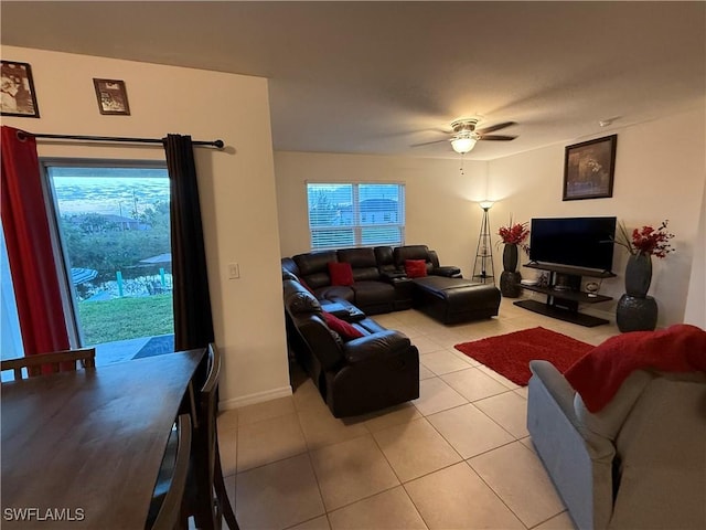 living area featuring ceiling fan and light tile patterned floors