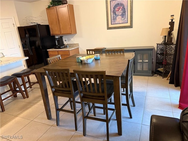 dining area featuring light tile patterned flooring