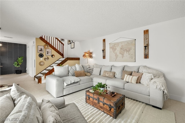 living room featuring light colored carpet and a textured ceiling