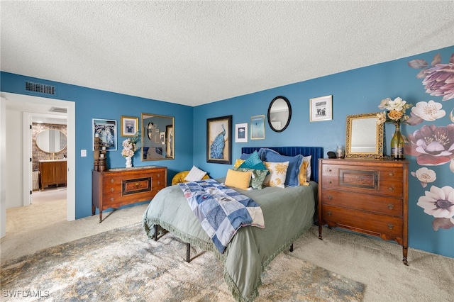 bedroom featuring a textured ceiling and light colored carpet