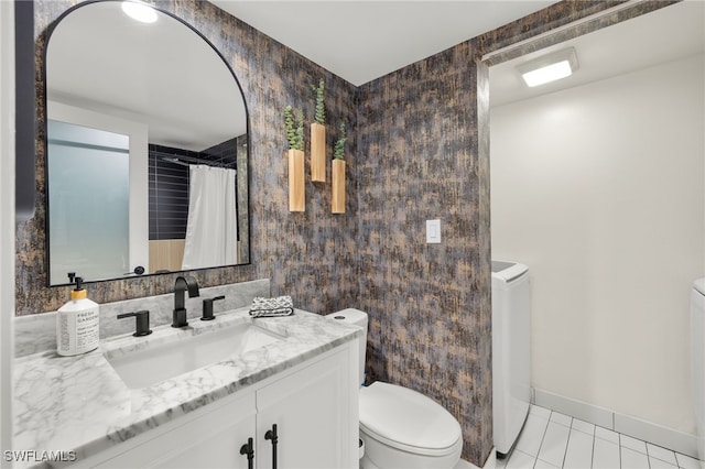 bathroom featuring tile patterned flooring, vanity, and toilet