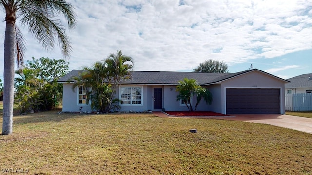 ranch-style home featuring a garage and a front lawn