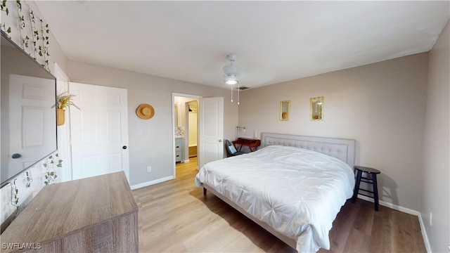 bedroom with ceiling fan and light hardwood / wood-style flooring