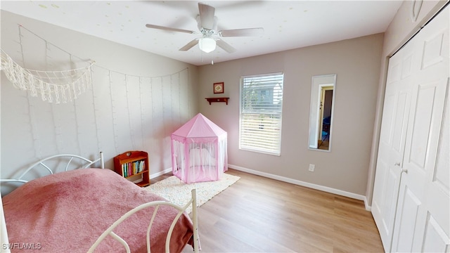 bedroom featuring light hardwood / wood-style floors, a closet, and ceiling fan