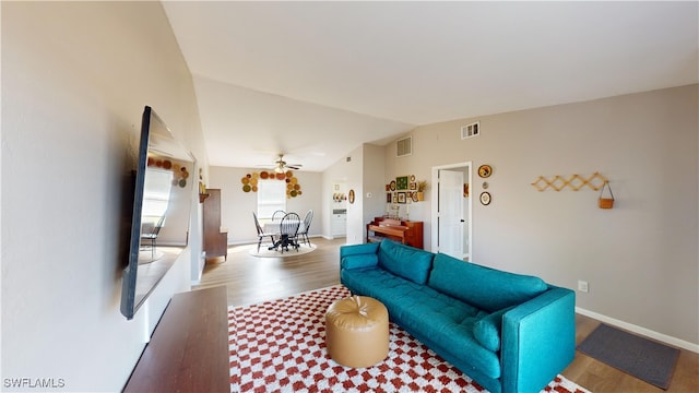 living room with ceiling fan, lofted ceiling, and wood-type flooring