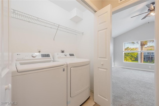 laundry room with light colored carpet, laundry area, a ceiling fan, baseboards, and washing machine and clothes dryer