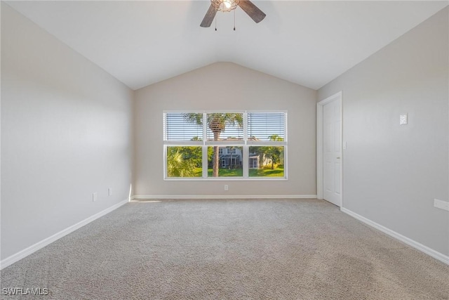 unfurnished room with carpet, baseboards, and vaulted ceiling