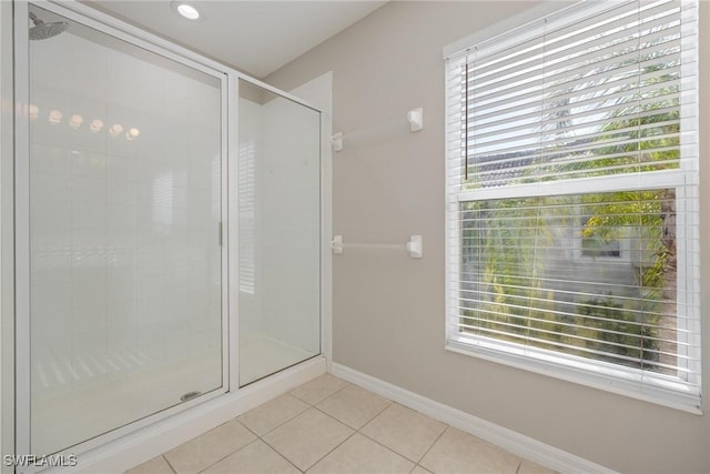 bathroom featuring a shower stall, a wealth of natural light, and tile patterned floors