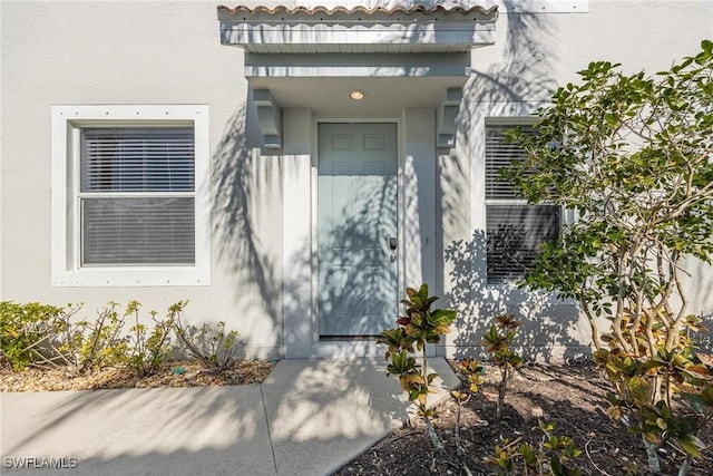 doorway to property with stucco siding