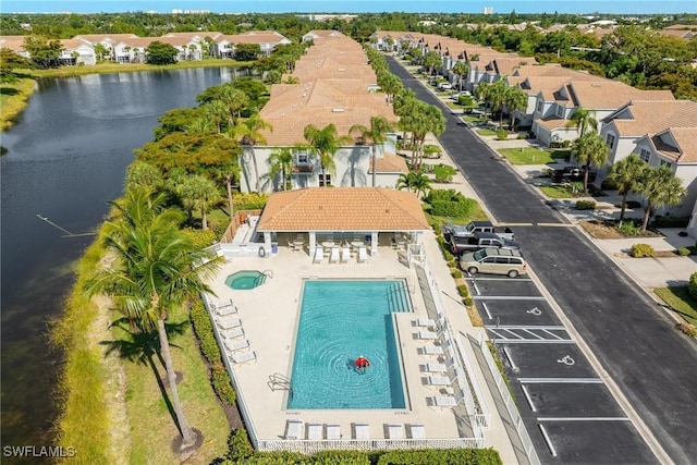 birds eye view of property with a water view and a residential view