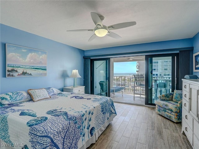 bedroom with ceiling fan, light hardwood / wood-style floors, and access to outside