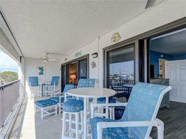 view of patio / terrace featuring ceiling fan and a balcony