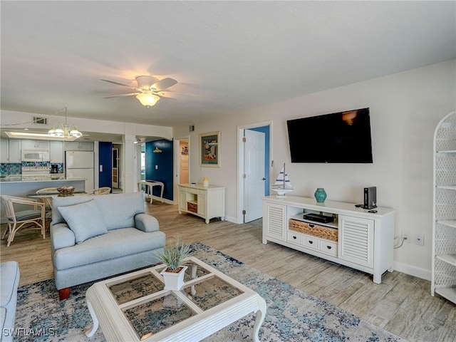 living room with ceiling fan and light hardwood / wood-style floors