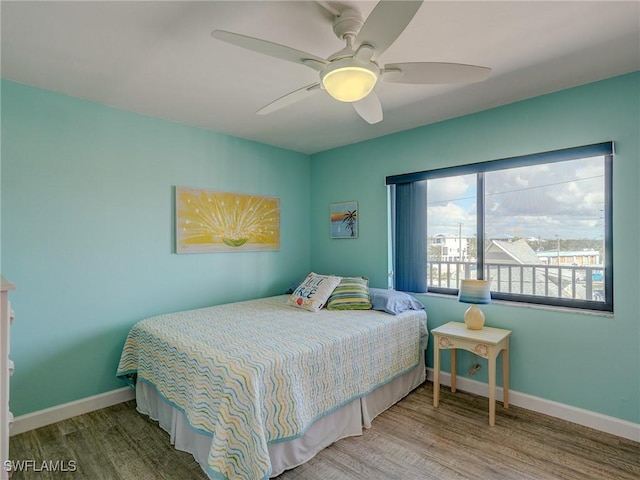 bedroom with ceiling fan and hardwood / wood-style floors