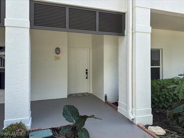1045 Tarpon Cove Dr Unit 102, Naples, FL 34110 - property entrance featuring visible vents and stucco siding