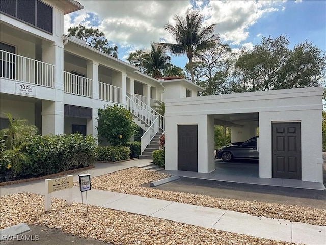 1045 Tarpon Cove Dr Unit 102, Naples, FL 34110 - view of property's community with stairway and a carport