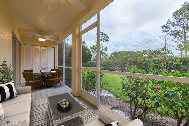 sunroom featuring a ceiling fan