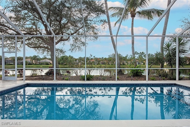 view of swimming pool featuring a lanai, a patio area, and a water view