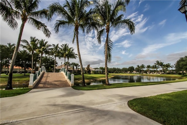 view of home's community featuring a water view and a yard