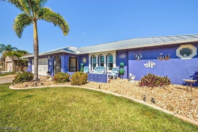 ranch-style house with a garage and a front lawn