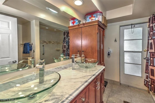 bathroom featuring vanity, a shower with curtain, and tile patterned floors