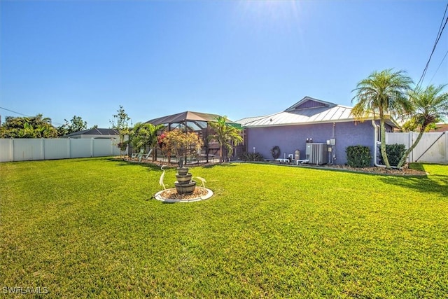 view of yard featuring cooling unit and a lanai