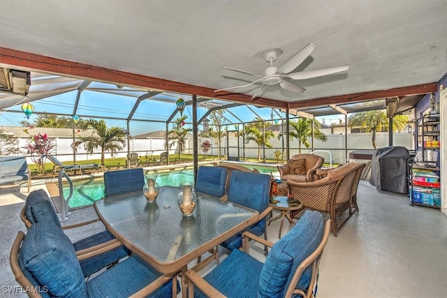 view of patio featuring ceiling fan, area for grilling, a fenced in pool, and glass enclosure