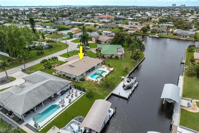 birds eye view of property with a water view